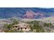 Exterior of home with tile roof nestled among trees and rolling hills, offering a peaceful retreat with scenic views at 15175 W Belleview Ave, Morrison, CO 80465