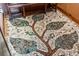 Close-up of a beautifully designed mosaic tile floor with intricate leaf patterns, adding a touch of artistry at 15175 W Belleview Ave, Morrison, CO 80465