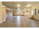 Spacious garage with epoxy flooring, ample cabinet storage, and well lit interior at 15175 W Belleview Ave, Morrison, CO 80465
