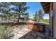 Outdoor hot tub with stone patio and mountain views at 15175 W Belleview Ave, Morrison, CO 80465