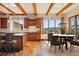 Open kitchen and dining area with wood cabinets, granite counters, and mountain views at 15175 W Belleview Ave, Morrison, CO 80465