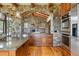 Elegant kitchen with stone accents, stainless steel appliances, and wooden cabinets at 15175 W Belleview Ave, Morrison, CO 80465
