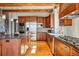Chef's kitchen boasting stainless appliances, custom cabinetry, a spacious island, and natural wood floors at 15175 W Belleview Ave, Morrison, CO 80465
