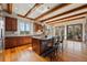 Gourmet kitchen with wood cabinets, granite countertops, and exposed beam ceilings at 15175 W Belleview Ave, Morrison, CO 80465