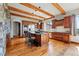 Open-concept kitchen featuring granite countertops, stainless appliances and wood cabinets at 15175 W Belleview Ave, Morrison, CO 80465