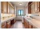Laundry room with custom cabinets and mountain views from the window at 15175 W Belleview Ave, Morrison, CO 80465