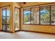 Bright living room featuring scenic views, stone accents, carpet flooring, and natural light at 15175 W Belleview Ave, Morrison, CO 80465