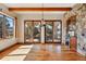 Bright living room featuring hardwood floors, stone accents, and sliding glass doors that lead to an outdoor patio at 15175 W Belleview Ave, Morrison, CO 80465
