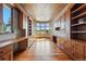 Large office space with custom cabinetry, built-in desks, and a unique ceiling design, offering ample storage at 15175 W Belleview Ave, Morrison, CO 80465