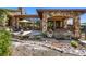 An outdoor living area featuring a stone patio, seating, and a dry creek bed for landscaping at 15175 W Belleview Ave, Morrison, CO 80465