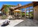 Outdoor patio with stone pavers, fire pit, dining set, and mountain views at 15175 W Belleview Ave, Morrison, CO 80465
