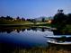 Dusk shot of a home's pond with paddleboards and mountain views at 15175 W Belleview Ave, Morrison, CO 80465