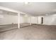 Large unfinished basement with support beams, offering potential for customization and expansion at 3306 S Uinta Ct, Denver, CO 80231