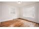 Bedroom featuring hardwood floors, neutral walls, and natural light from two windows at 3306 S Uinta Ct, Denver, CO 80231