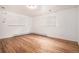 Bedroom featuring hardwood floors, neutral walls, and natural light from two windows at 3306 S Uinta Ct, Denver, CO 80231