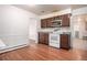 A kitchen featuring a white stove and brown cabinets, ready for modern upgrades at 3306 S Uinta Ct, Denver, CO 80231