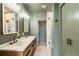 Elegant bathroom featuring dual sinks, modern fixtures, marble floors, and a luxurious walk-in shower at 2680 Blake St # 4, Denver, CO 80205