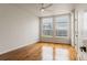 Bright bedroom featuring hardwood floors, a ceiling fan, and large windows with city views at 2680 Blake St # 4, Denver, CO 80205
