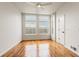 Sun-filled bedroom featuring hardwood floors, large windows, and closet at 2680 Blake St # 4, Denver, CO 80205
