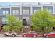 Exterior shot of townhomes with brick facade, multiple windows, and small iron balconies at 2680 Blake St # 4, Denver, CO 80205