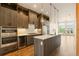 Modern kitchen with stainless steel appliances, island, and stylish pendant lighting at 2680 Blake St # 4, Denver, CO 80205