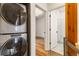 Convenient laundry area with modern stacked washer and dryer, and access to the bathroom at 2680 Blake St # 4, Denver, CO 80205