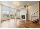 Bright living room featuring large windows, a modern fireplace, and hardwood floors at 2680 Blake St # 4, Denver, CO 80205