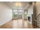 Bright living room featuring large windows, a modern fireplace, and hardwood floors at 2680 Blake St # 4, Denver, CO 80205