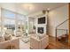 Living room featuring modern fireplace, staircase, and large windows with lots of light at 2680 Blake St # 4, Denver, CO 80205
