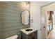 Modern powder room with unique backsplash, stylish mirror, and elegant fixtures at 2680 Blake St # 4, Denver, CO 80205