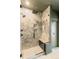 Walk-in shower with elegant marble tiling, a built-in seat, a rainfall showerhead, and modern fixtures at 2680 Blake St # 4, Denver, CO 80205
