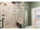 Beautiful walk-in shower with marble tile, built-in shelving, a seat, and modern fixtures at 2680 Blake St # 4, Denver, CO 80205