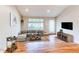 Bright living room with hardwood floors, stylish furniture, and a large window for natural light at 3124 W 26Th Ave, Denver, CO 80211