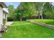 Lush backyard featuring a well manicured lawn, landscaping features, and shade trees at 801 S Harrison St, Denver, CO 80209