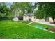 Lush backyard featuring a well manicured lawn, a garden bench and a patio at 801 S Harrison St, Denver, CO 80209