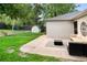A well manicured backyard features green grass and modern patio furniture, with a shed in the back at 801 S Harrison St, Denver, CO 80209