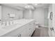 Modern bathroom featuring a double vanity, large mirror, and glass shower at 801 S Harrison St, Denver, CO 80209