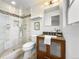 Modern bathroom featuring a walk-in shower, updated vanity, and neutral color palette at 801 S Harrison St, Denver, CO 80209