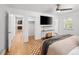 Spacious bedroom featuring hardwood floors, ceiling fan, and ample closet space at 801 S Harrison St, Denver, CO 80209