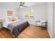 Inviting bedroom with a comfortable bed, shuttered window, wood floors, and a cozy chair at 801 S Harrison St, Denver, CO 80209