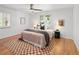 Bright bedroom with a plush bed, ceiling fan, wood floors, and a cozy rug at 801 S Harrison St, Denver, CO 80209