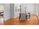 Open dining room with hardwood floors, a glass table, and neutral decor for an inviting atmosphere at 801 S Harrison St, Denver, CO 80209