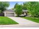 Charming home featuring a lush green lawn, long driveway, and a two-car garage, offering comfort and convenience at 801 S Harrison St, Denver, CO 80209