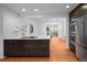 Open concept kitchen with island and hardwood floors leading to living area at 801 S Harrison St, Denver, CO 80209