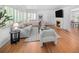 Comfortable living room with hardwood floors, fireplace, and plantation shutters at 801 S Harrison St, Denver, CO 80209