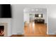 Living room with fireplace flows into updated kitchen with island at 801 S Harrison St, Denver, CO 80209