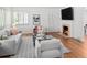 Cozy living room with hardwood floors, a fireplace, and plenty of comfortable seating at 801 S Harrison St, Denver, CO 80209