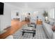Bright living room featuring hardwood floors and an open layout to dining and kitchen at 801 S Harrison St, Denver, CO 80209