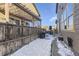 View of the backyard patio with a grill, pergola, and snow covered ground at 10246 Tall Oaks Cir, Parker, CO 80134