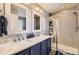 Stylish bathroom featuring a double sink vanity with marble countertop and glass-enclosed shower at 10246 Tall Oaks Cir, Parker, CO 80134